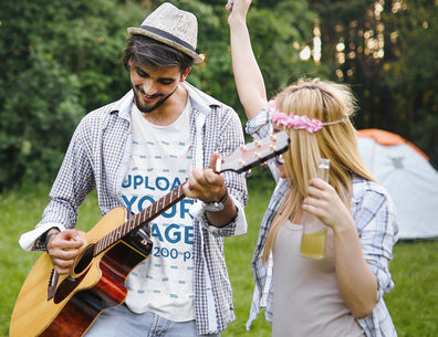 T-Shirt Mockup of a Man Playing a Guitar to Celebrate Canada Day with His Girlfriend