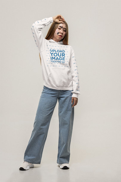 Mockup of a Woman Proud of Her Skin Posing in a Gildan Pullover Hoodie m32941