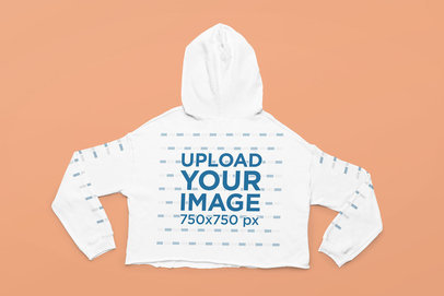 Back-View Mockup Featuring a Crop Top Hoodie Laid over a Solid Surface
