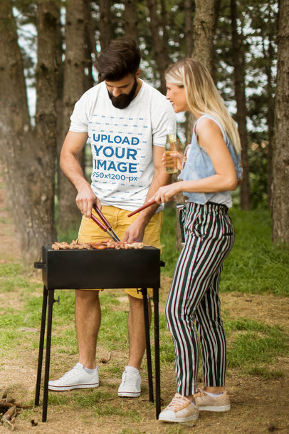 Canada Day-Themed T-Shirt Mockup of a Bearded Man Grilling Meat with His Girlfriend