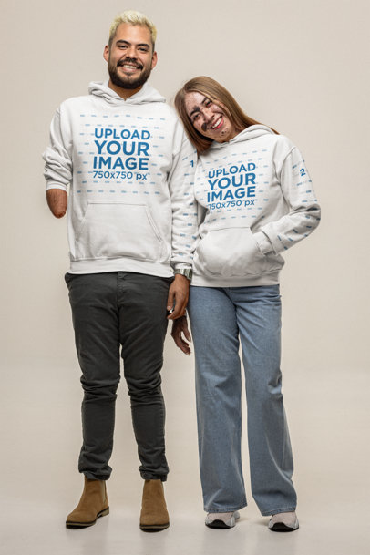 Gildan Pullover Hoodie Mockup of a Joyful Couple Posing Together in a Studio