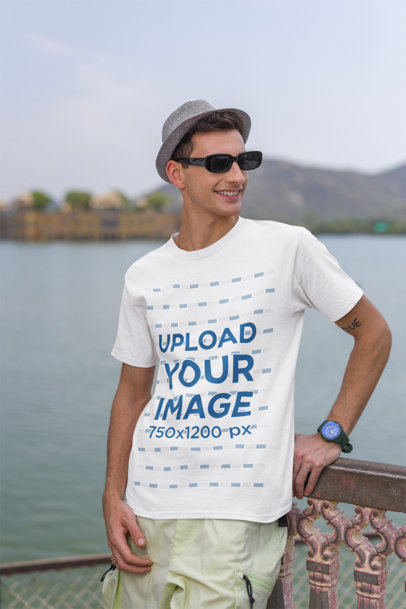 Travel-Themed Mockup of a Cheerful Man Wearing a Gildan Round-Neck T-Shirt