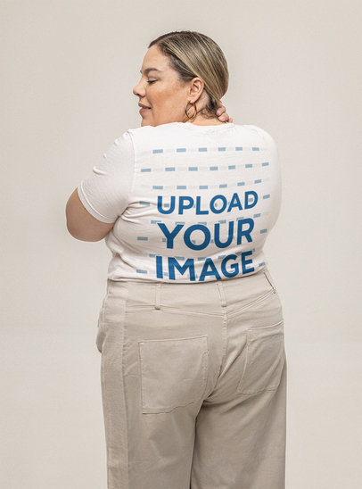 Back-View Mockup of a Woman Wearing a Bella Canvas T-Shirt in a Studio