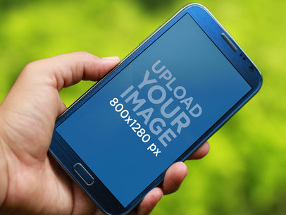 Mockup of a Person Holding a Blue Samsung Galaxy Note