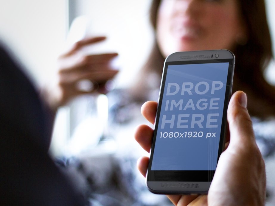 Black HTC Mockup Featuring a Young Couple Having Drinks