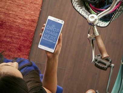 Galaxy Note Mockup Featuring a Woman and a Bike at Her Apartment