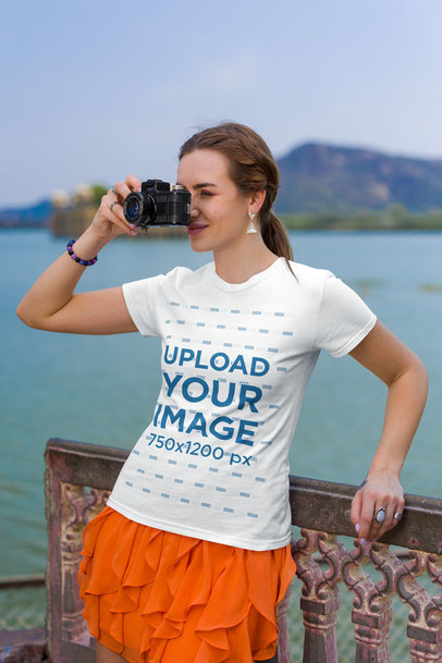 Gildan T-Shirt Mockup Featuring a Woman Taking Pictures with Her Camera