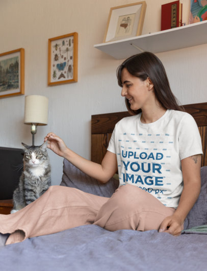 Round-Neck Bella Canvas Tee Mockup of a Woman Petting Her Cat at Home