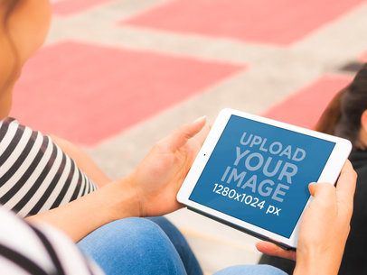 iPad Mini Mockup Featuring a Woman Sitting on Stairs
