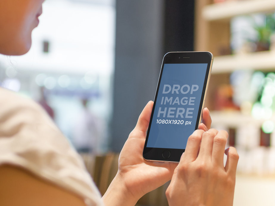 iPhone 6 Mockup Featuring a Woman in a Tea Shop