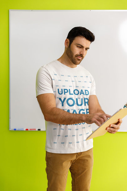 Bella Canvas T-Shirt Mockup Featuring a Bearded Teacher Posing in Front of a Whiteboard