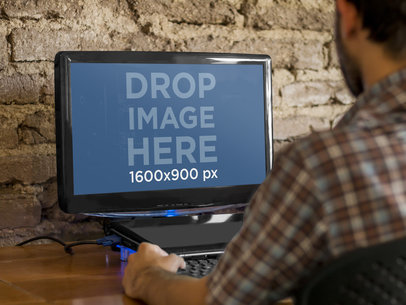 PC Mockup Featuring a Man Working Hard at the Office
