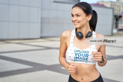 Sports Bra Mockup Featuring a Female Jogger with Headphones Around Her Neck m29082 r-el2