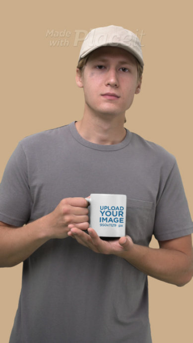 Video of a Man Holding an 11 Oz Coffee Mug in a Studio