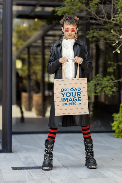 Mockup of a Man in a Harajuku-Inspired Outfit Holding a Sublimated Tote Bag