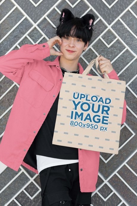 Cosplay-Themed Mockup of a Smiling Man With Cat Ears Carrying a Tote Bag
