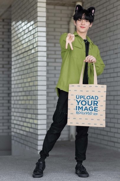 Tote Bag Mockup Featuring a Man in a Harajuku-Inspired Cosplay
