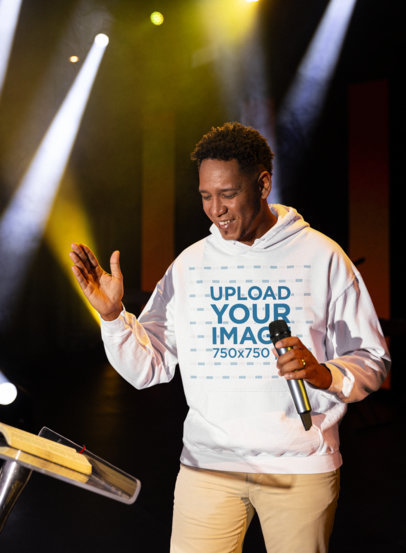 Gildan Hoodie Mockup Featuring a Christian Preacher Holding a Microphone m34667