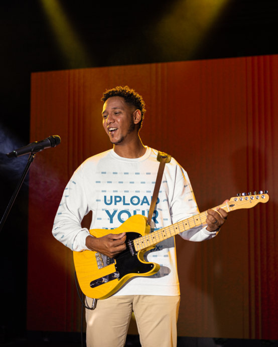 Gildan Sweatshirt Mockup Featuring a Man Playing the Guitar in a Christian Forum