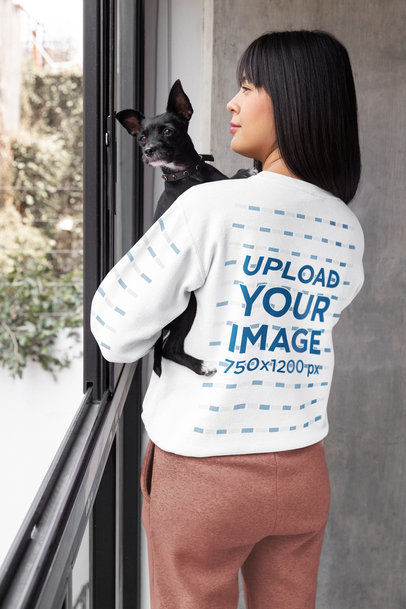 Back-View Gildan Sweatshirt Mockup of a Woman Holding Her Dog