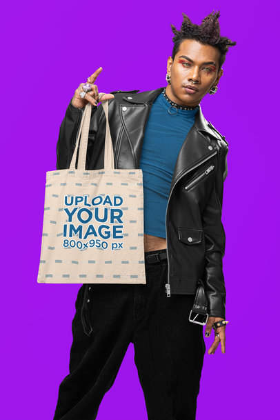 Alternative-Inspired Mockup of a Man Holding a Tote Bag in a Studio