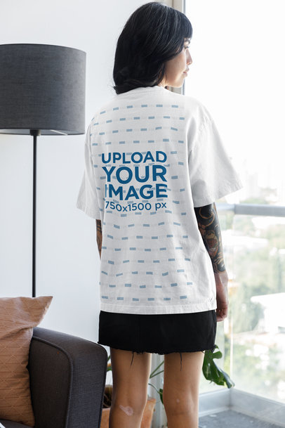 Back-View Oversized T-Shirt Mockup Featuring a Woman Looking at a Window m31702
