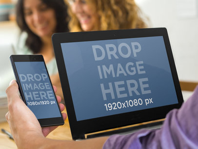 Asus Laptop and Sony Xperia Mockup Featuring a Man Multitasking with People in the Background