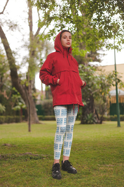 Mockup of a Girl Wearing Leggings and a Red Hooded Coat at a Park a19197
