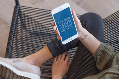 Top Shot Mockup of a Woman Holding a Gold iPhone 8 Plus