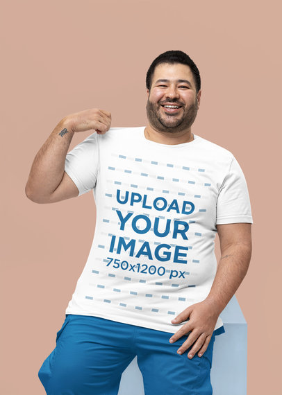 Mockup of a Happy Man Showing Off His New Bella Canvas T-Shirt 