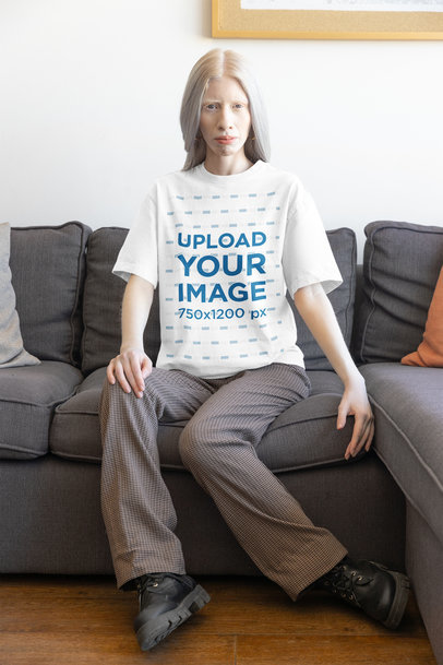 Oversized Round-Neck Tee Mockup of a Woman Sitting on a Sofa at Home