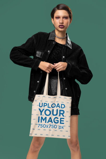 Alternative-Style Mockup of a Woman Carrying a Sublimated Tote Bag in a Studio
