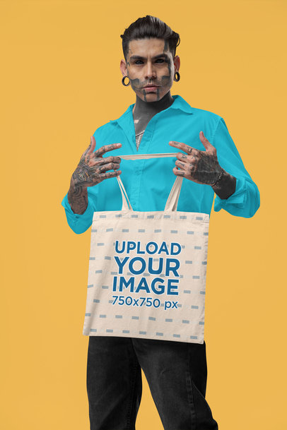 Sublimated Tote Bag Mockup of a Tattooed Serious Man Posing in a Studio With an Alternative Style m31670
