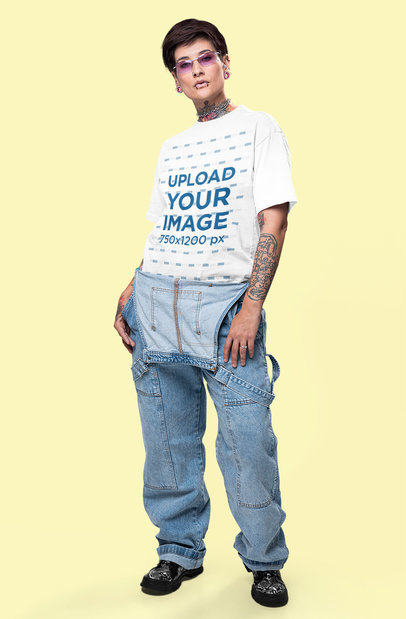 Oversized T-Shirt Mockup Featuring a Tattooed Woman With an Alternative Style in a Studio