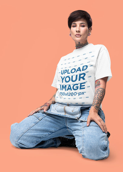 Alternative-Inspired Mockup of a Woman with Arm Tattoos Wearing an Oversized Tee