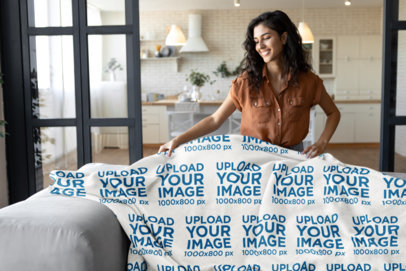Mockup of a Woman Putting a Sublimated Fleece Blanket on a Couch