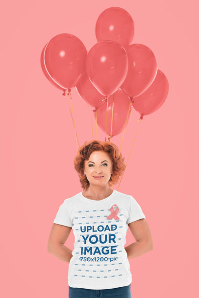 T-Shirt Mockup of a Smiling Woman Posing in a Studio With Balloons for Cancer Awareness