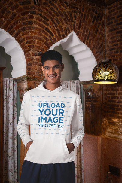 Gildan Pullover Hoodie Mockup Featuring a Happy Man Posing Against a Brick Column