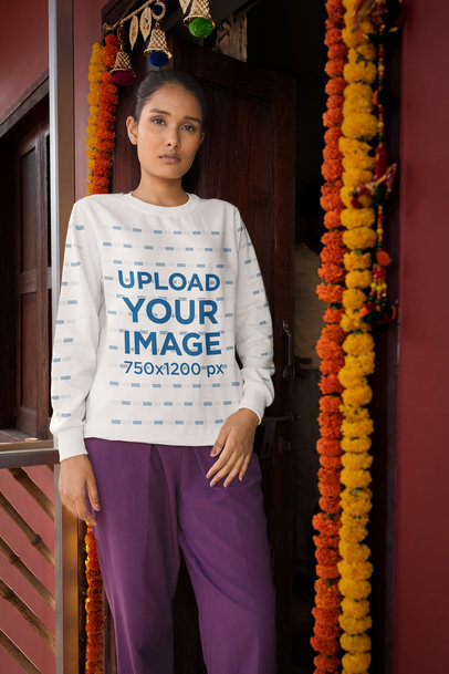 Sweatshirt Mockup of a Woman Standing by a Door Decorated with Flowers
