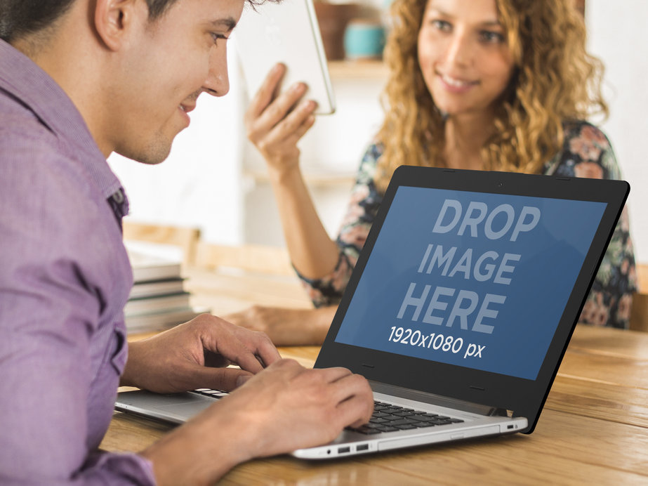 Asus Laptop Mockup Featuring Two Coworkers at the Office