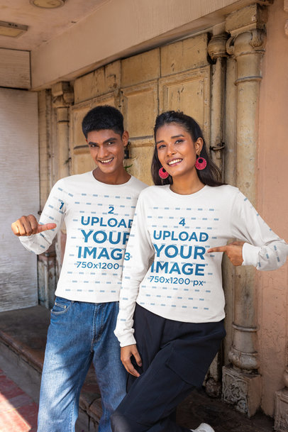 Mockup of a Man and a Woman Pointing at Their Bella Canvas Long Sleeve T-Shirts