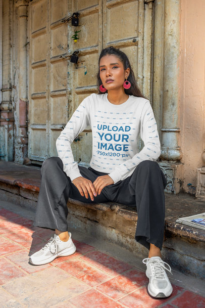 Bella Canvas Long-Sleeve Tee Mockup Featuring a Serious Woman Sitting in an Old Building