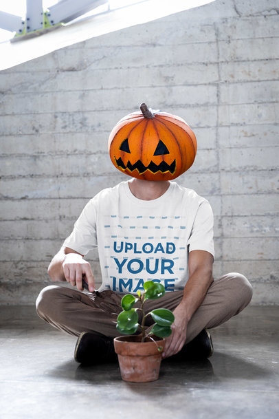 Halloween-Themed Stanley Stella Tee Mockup of a Man with a Pumpkin Face