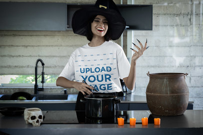 Stanley Stella Tee Mockup of a Smiling Witch Cooking in a Modern Kitchen