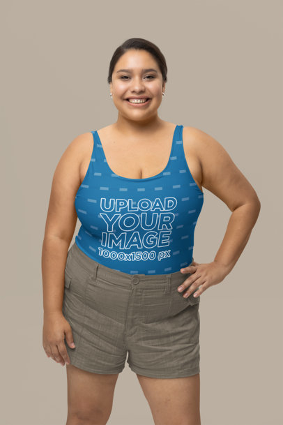 Mockup of a Smiling Woman Wearing a Sublimated One-Piece Swimsuit at a Studio