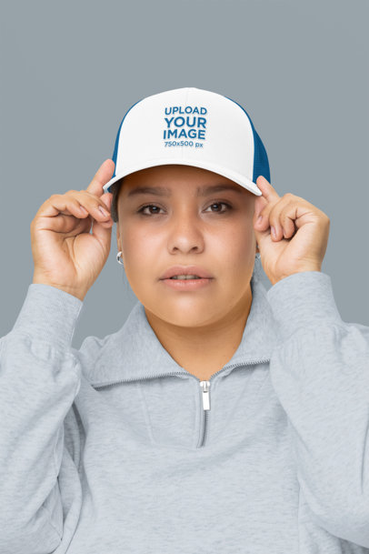 Mockup Featuring a Woman Wearing a Trucker Hat in a Studio m34568