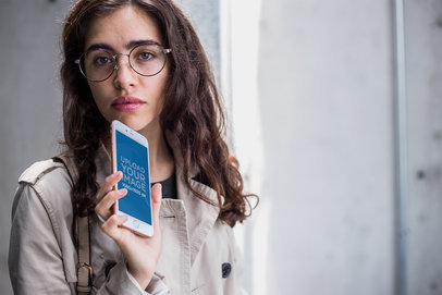 Rose Gold iPhone 7 Plus Mockup Being Held by a Woman in a Trench Coat