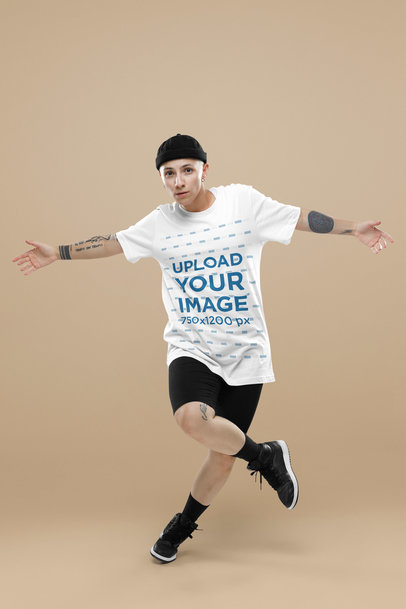 Bella Canvas T-Shirt Mockup Featuring a Tattooed Woman Dancing in a Studio