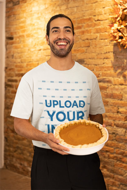 Stanley Stella Tee Mockup of a Happy Man Holding a Pumpkin Pie