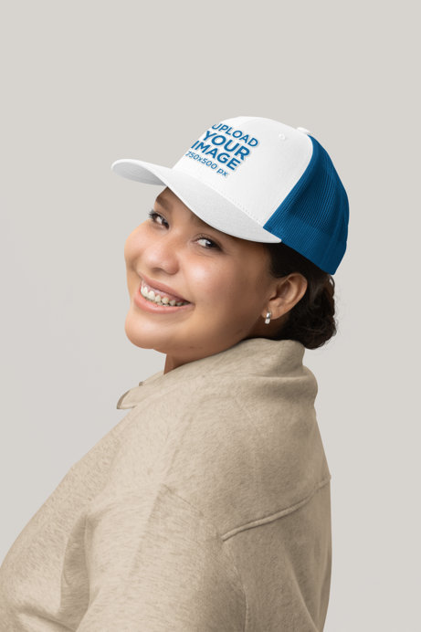 Yupoong Trucker Hat Mockup of a Cheerful Woman Posing in a Studio